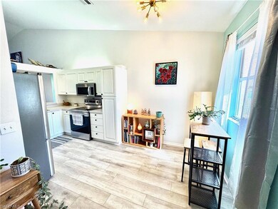 Kitchen with stainless steel appliances, white cab