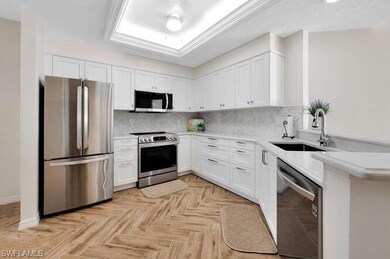 Kitchen featuring sink, white cabinetry, stainless