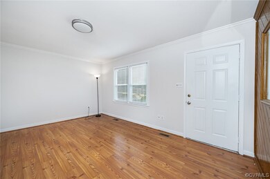 Living room with view of front entry to home.