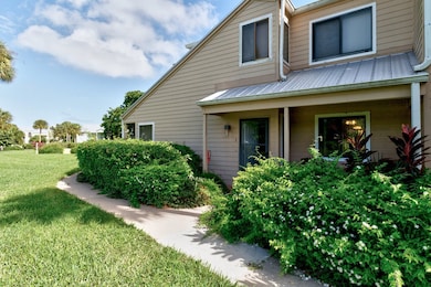 View of side of property featuring a lawn, a metal roof, and covered​​‌​​​​‌​​‌‌​​​‌​​‌‌​‌‌​​​‌‌‌​​​​‌​​​​​‌ porch