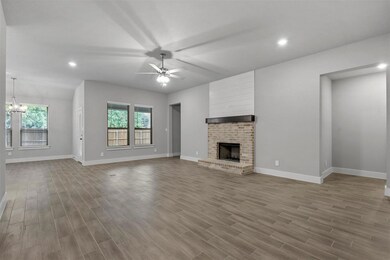Unfurnished living room featuring a fireplace, lig