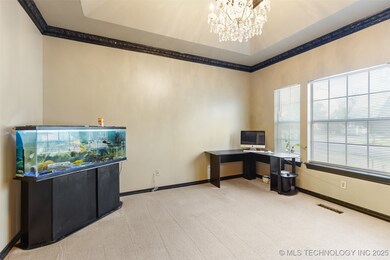 Carpeted home office with ornamental molding, a ch