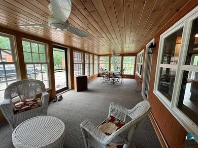 Sunroom / solarium featuring wooden ceiling and ce