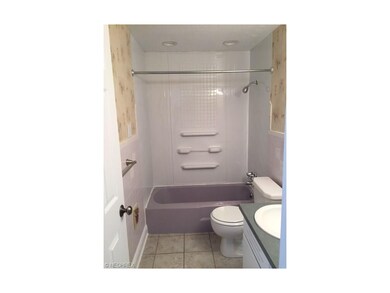 Nice ceramic tile floor and newer tub surround.