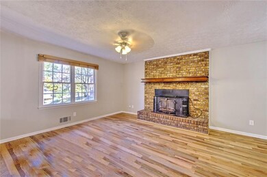 Unfurnished living room with a textured ceiling, l