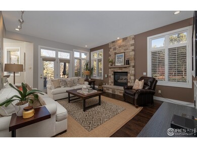 Den/family/living room w/ large stone fireplace.