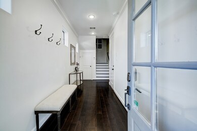 Spacious foyer adorned with attractive dark-staine