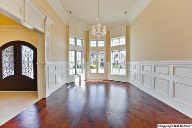 Front of house, Extensive trim. 14' ceilings, chandelier, bay window, hardwood floors. This is the Christmas tree room for sure!