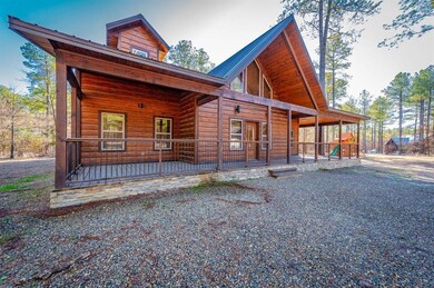 Chalet / cabin with covered porch, faux log siding, and metal roof