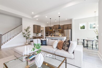 Great Room featuring light wood-style flooring, recessed lighting, and stairway.