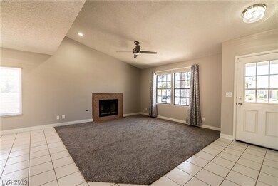 Great room features vaulted ceiling, cozy gas fire