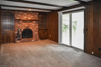 The family room features a brick fireplace framed 