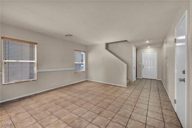 Foyer with light tile patterned floors and baseboa