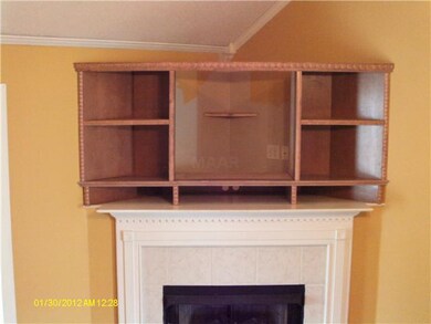 Entertainment center above fireplace in living roo