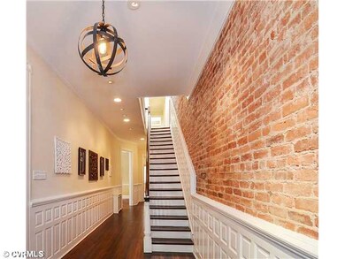Foyer - Exposed brick, walnut stained floors, rece