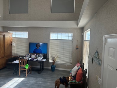 Home office with plenty of natural light and dark wood-style floors