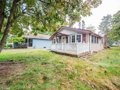 Rear view of property featuring a lawn and a deck