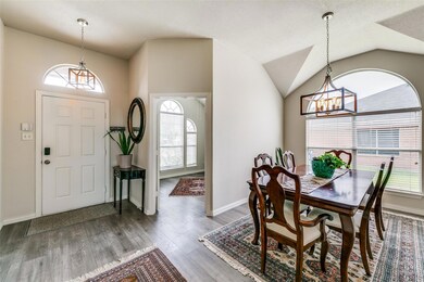 Dining space with dark wood-type flooring, lofted ceiling, and plenty of natural light
