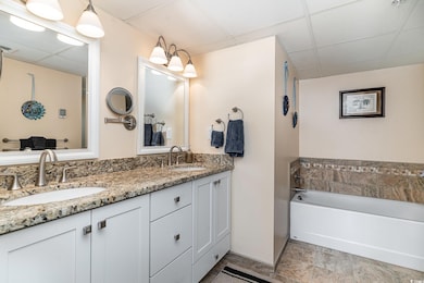 Bathroom featuring vanity, a paneled ceiling, and 