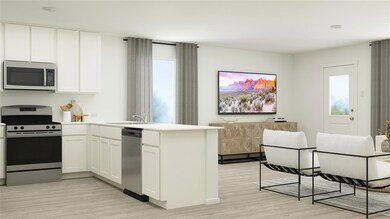 Kitchen with white cabinetry, sink, plenty of natu