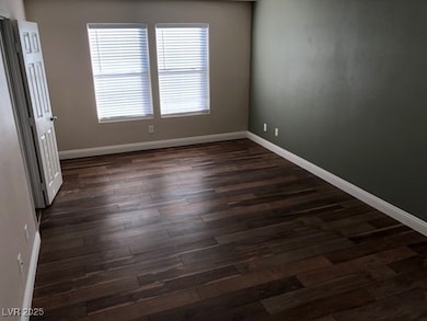 Empty room featuring dark wood-style floors