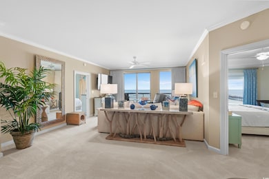 Living room with a ceiling fan, crown molding, light carpet, and baseboards