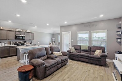Living room featuring sink and light wood-look til