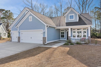 View of front of property featuring a porch, drive