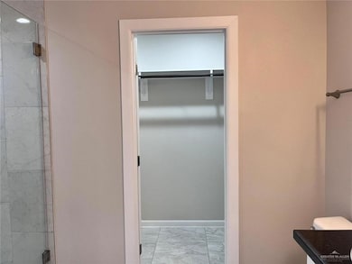 Bathroom with a shower with door and vanity