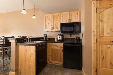 Kitchen featuring light brown cabinets, sink, hang