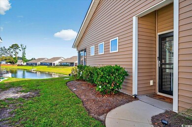 View of property exterior featuring a yard, a residential view, and a water view