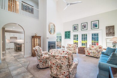 Living room with a high ceiling and ceiling fan