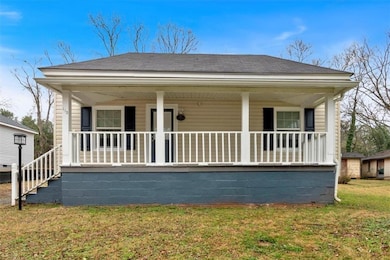 Front of house featuring a yard and covered porch