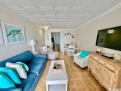 Living area with light tile patterned flooring and an ornate ceiling