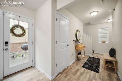 foyer with access to garage, storage, and backyard