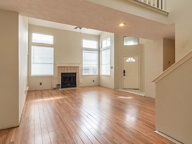 The family room has a fireplace and windows all around.