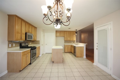 Spacious kitchen with modern appliances, viewed fr