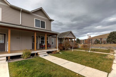 View of front of house with covered porch and a front lawn