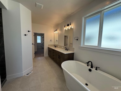 Bathroom featuring a freestanding bath and double vanity