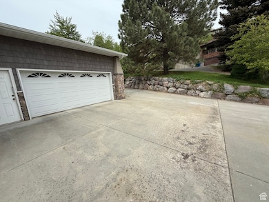 Garage featuring concrete driveway