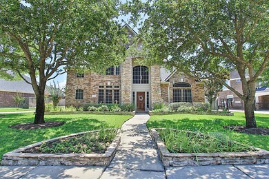 Beautifully landscaped yard enhances curb appeal of this immaculate 2 story stone elevation Trendmaker home.