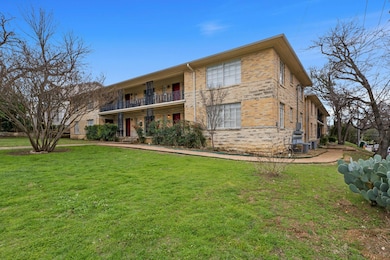 View of front of home featuring a balcony, a fron