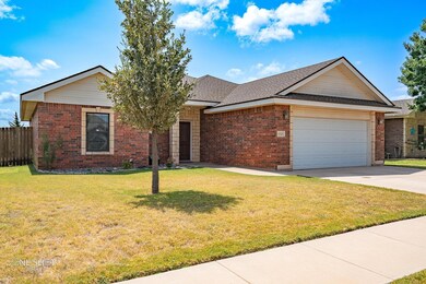 Ranch-style home with a front lawn and a garage