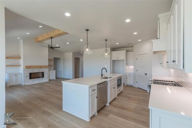 Kitchen featuring white cabinetry, dishwasher, a k