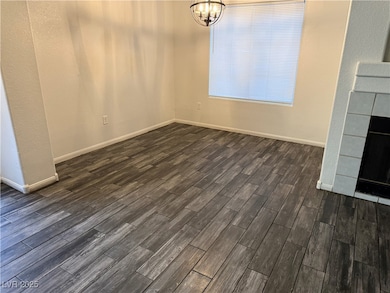 Unfurnished dining area with dark wood-style floor