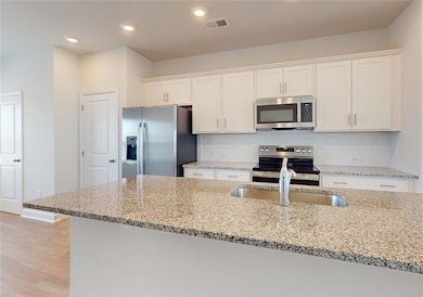 Kitchen featuring appliances with stainless steel 