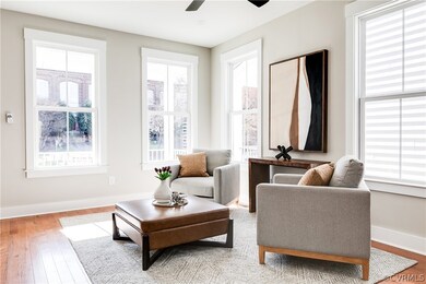 Sitting room with light wood-type flooring, a weal
