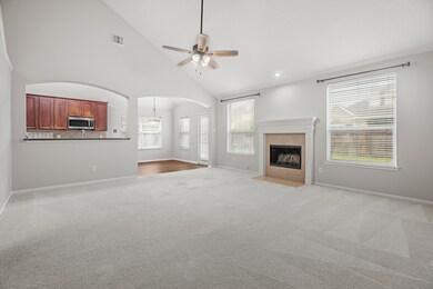 Large living room overlooks a spacious backyard.