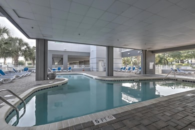 Indoor community pool with a patio area and fence