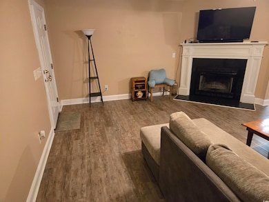 Living room with dark hardwood / wood-style floors